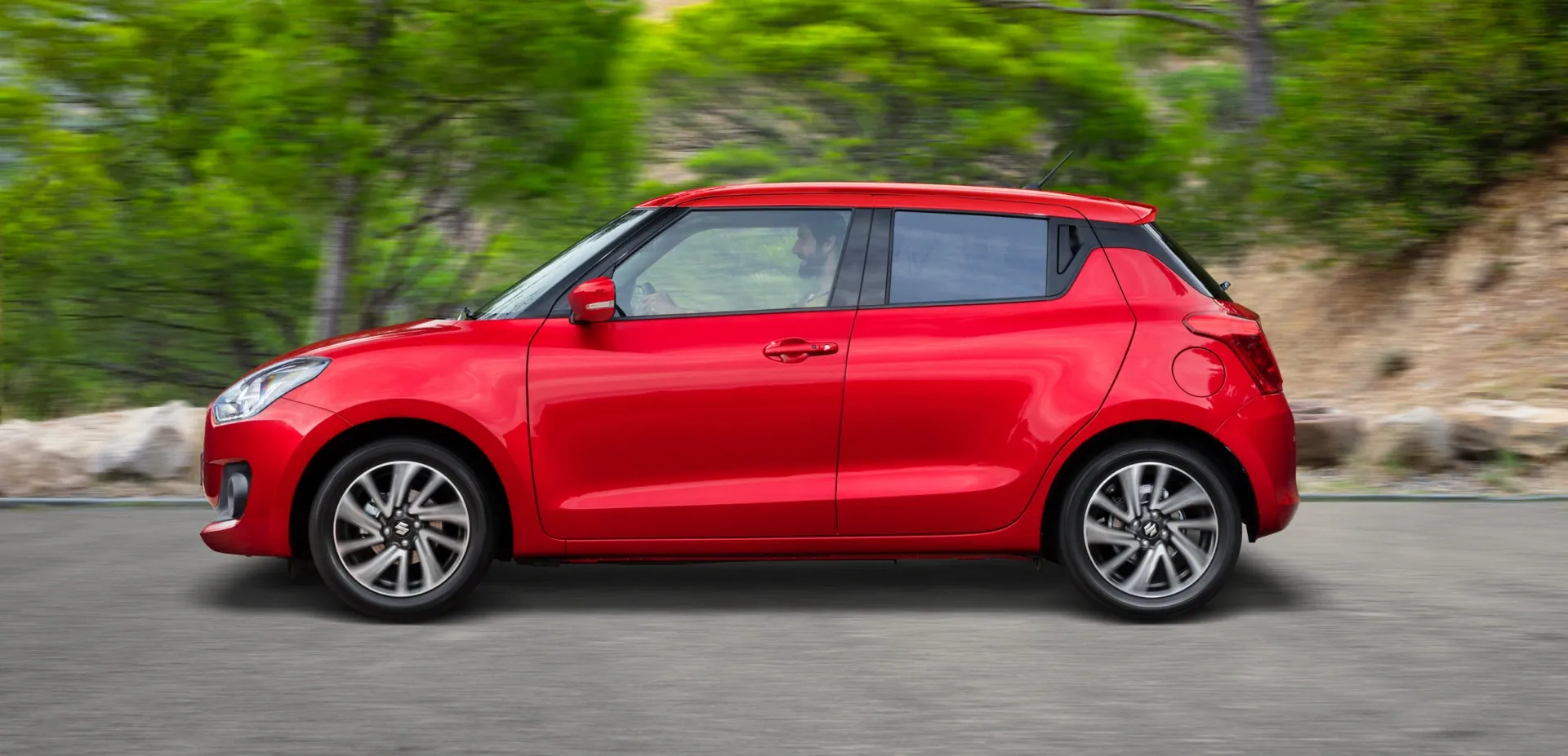 2025 Suzuki Swift Hybrid GLX Review Roundup-Side View in Motion 