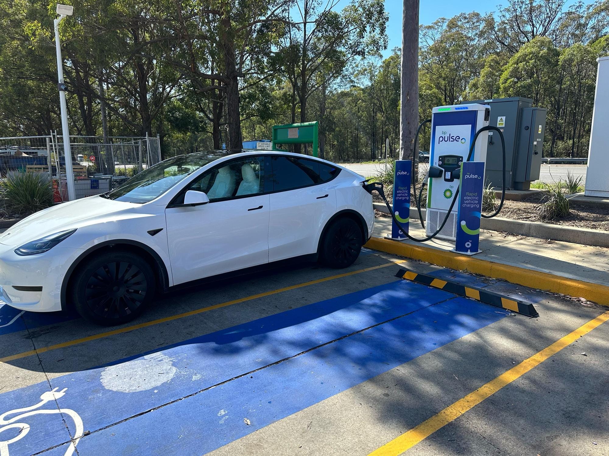 Telsa Recharging EV at BP Pulse 